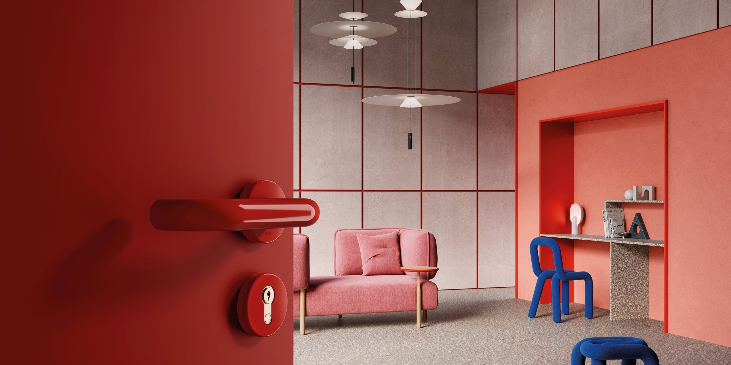 A red door handle with a rose and keyhole on a red door; behind it, a living room with a workspace