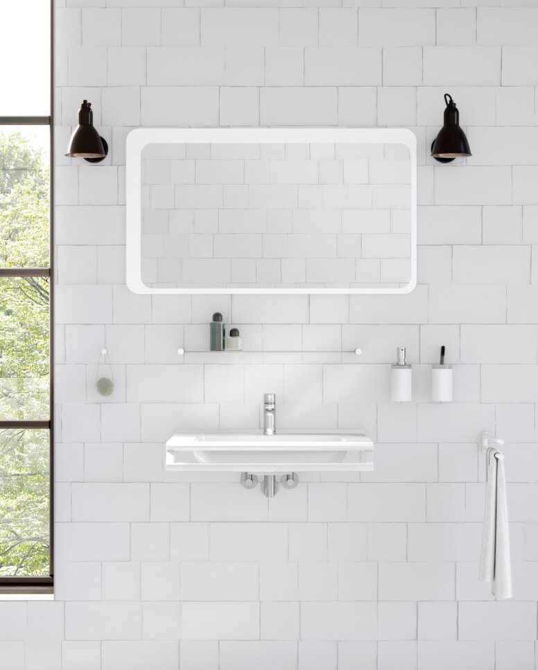 HEWI System 162 Interior A washbasin with a side-mounted towel holder beneath a rectangular mirror with integrated lighting in the wash area, set against a white tiled wall