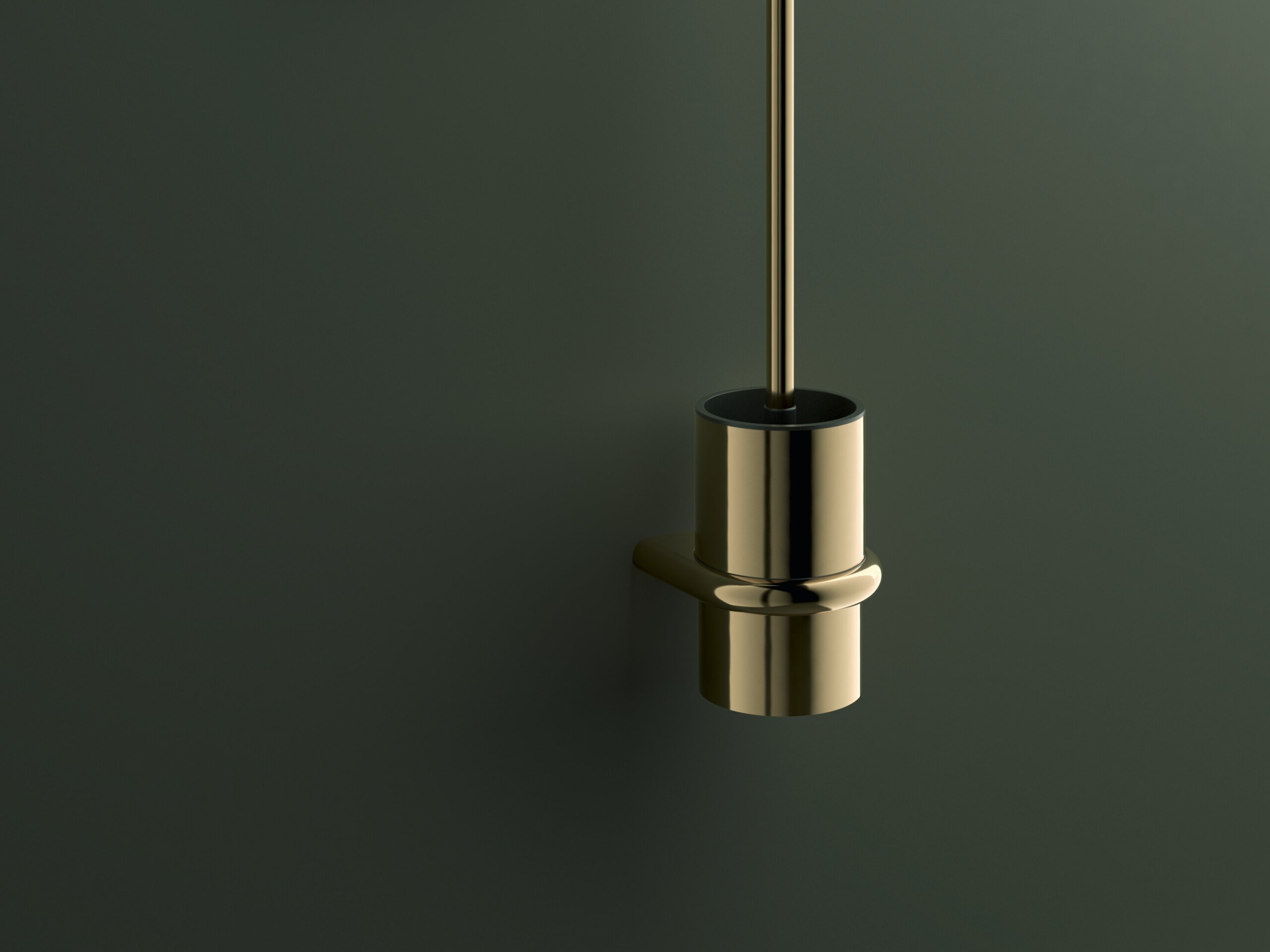 Wall-mounted toilet brush and toilet roll holder with a brass-coloured PVD coating on a dark green wall