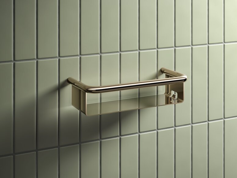 HEWI Range 480 PVD shower basket Shower basket with a brass-coloured PVD coating against a backdrop of light green tiles