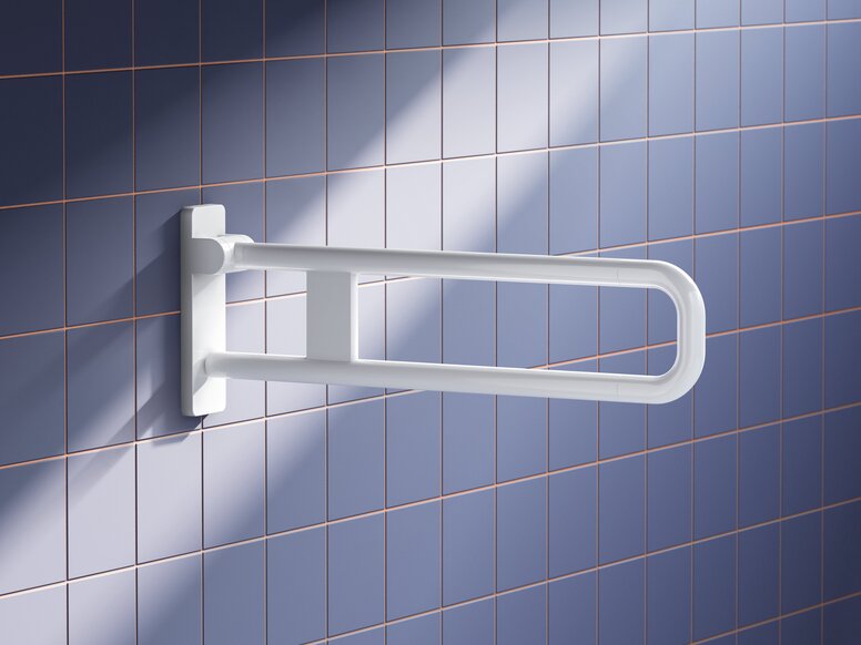 HEWI System 700 hinged support rail White wall-mounted plastic hinged support rail with two joined tubes and a rounded front on a blue tiled wall