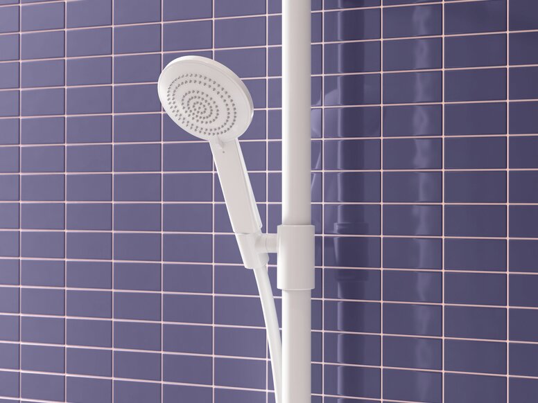 HEWI System 700 rail with shower head holder White plastic shower rail with an adjustable shower head holder and round hand shower on a blue tiled wall