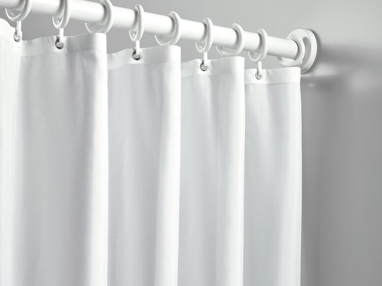 HEWI Range 801 curtain rail A shower curtain with white rings, hung on a white curtain rail against a light grey wall