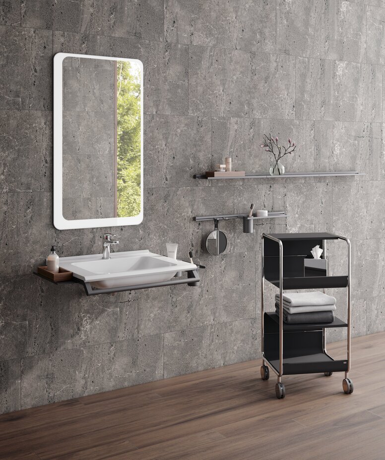HEWI S950 Interior Washbasin with a side shelf and a front support rail, above which is a rectangular mirror with rounded corners in the wash area
