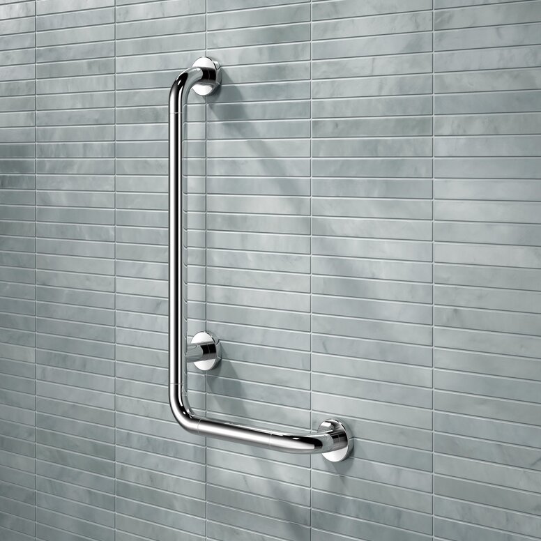 HEWI WARM TOUCH L-shaped support rail A chrome-plated L-shaped support rail mounted on a wall in front of light blue tiles