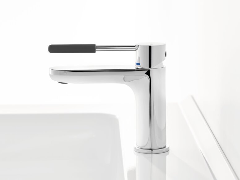 Chrome-plated tap with a long lever handle and dark grey grip sleeve on a white washbasin against a white background